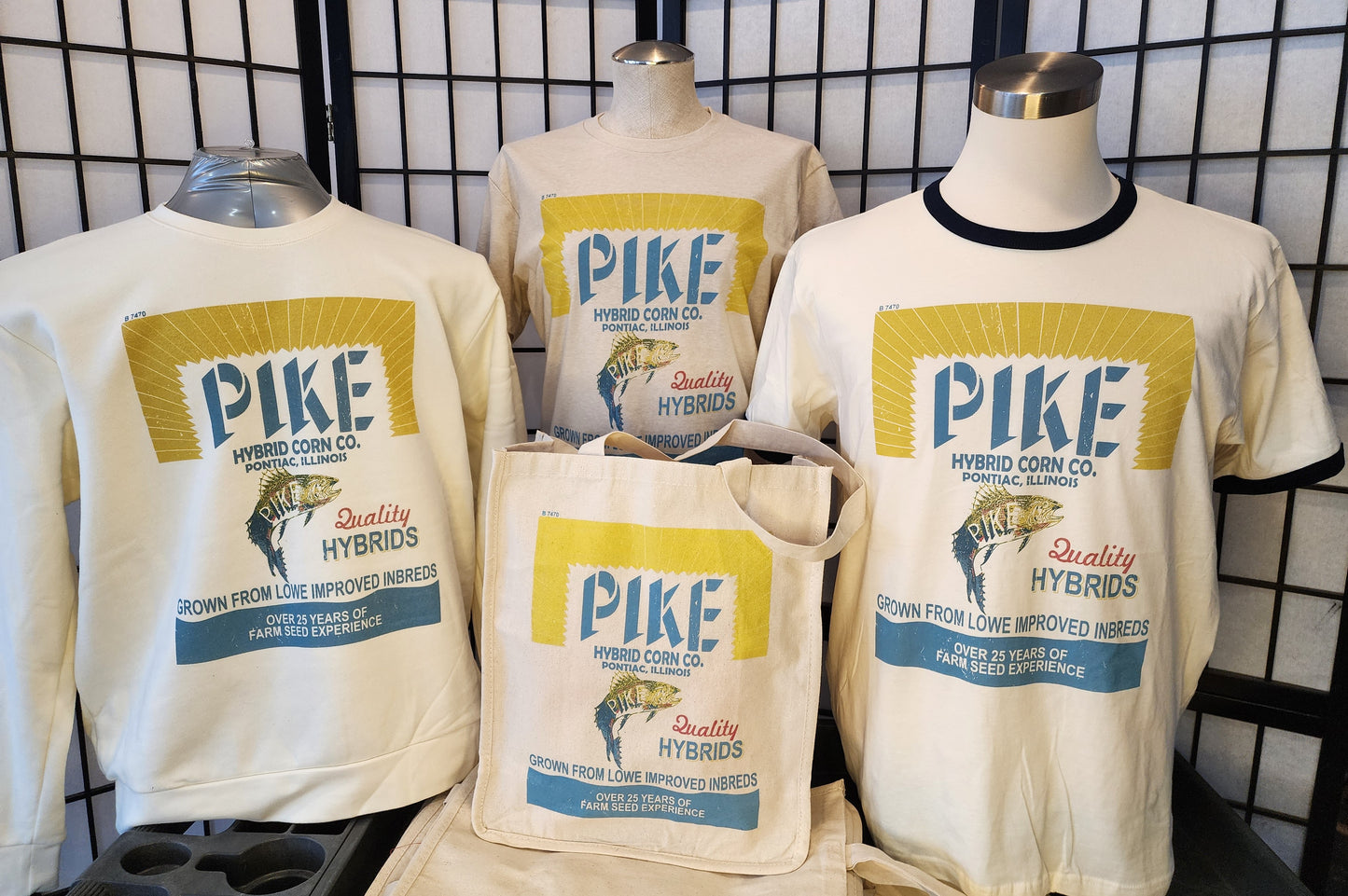Pontiac, Illinois "Pike Hybrid Corn Co" vintage seed bag design, Next-Level Ringer Tee, Natural/Navy
